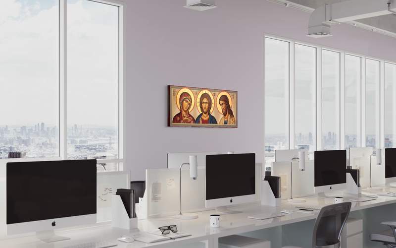 Triptych of hand-painted icons in a bright open-plan office